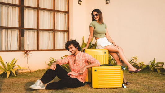 How to Plan Budget-Friendly Trips: Smart Travel Hacks – a young couple with Timus Neolite Hard Luggage in bright yellow, perfect for stylish and affordable travel.