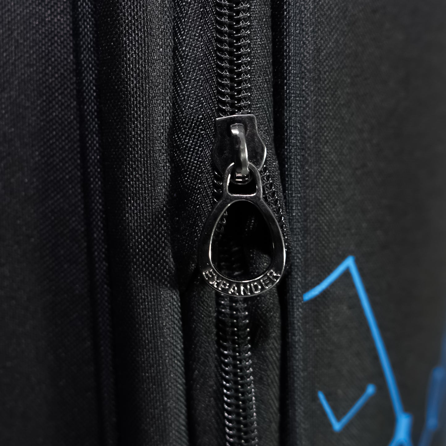 Expandable zipper on black Flash Plus soft luggage to increase capacity