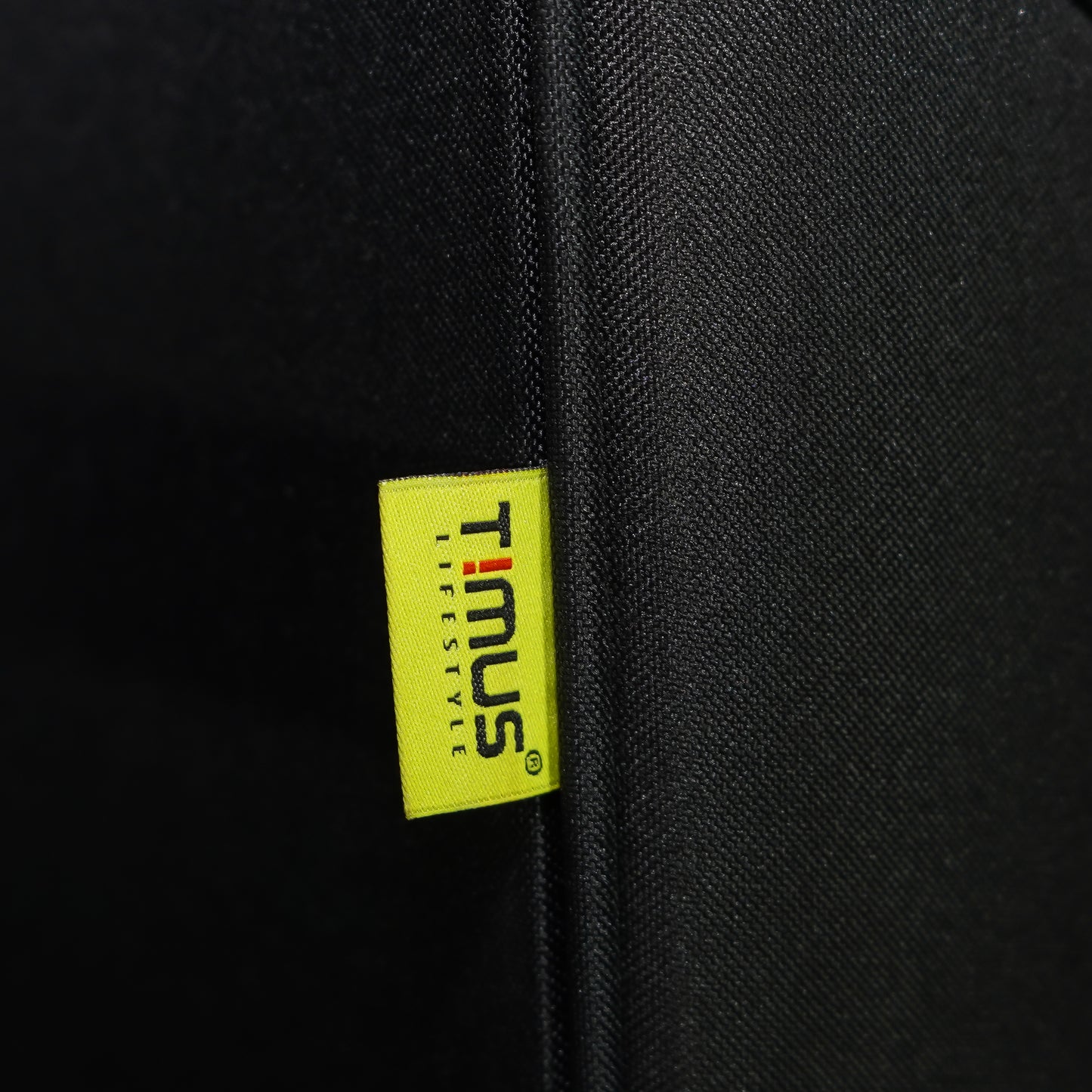 Timus brand tag on black Flash Plus soft luggage