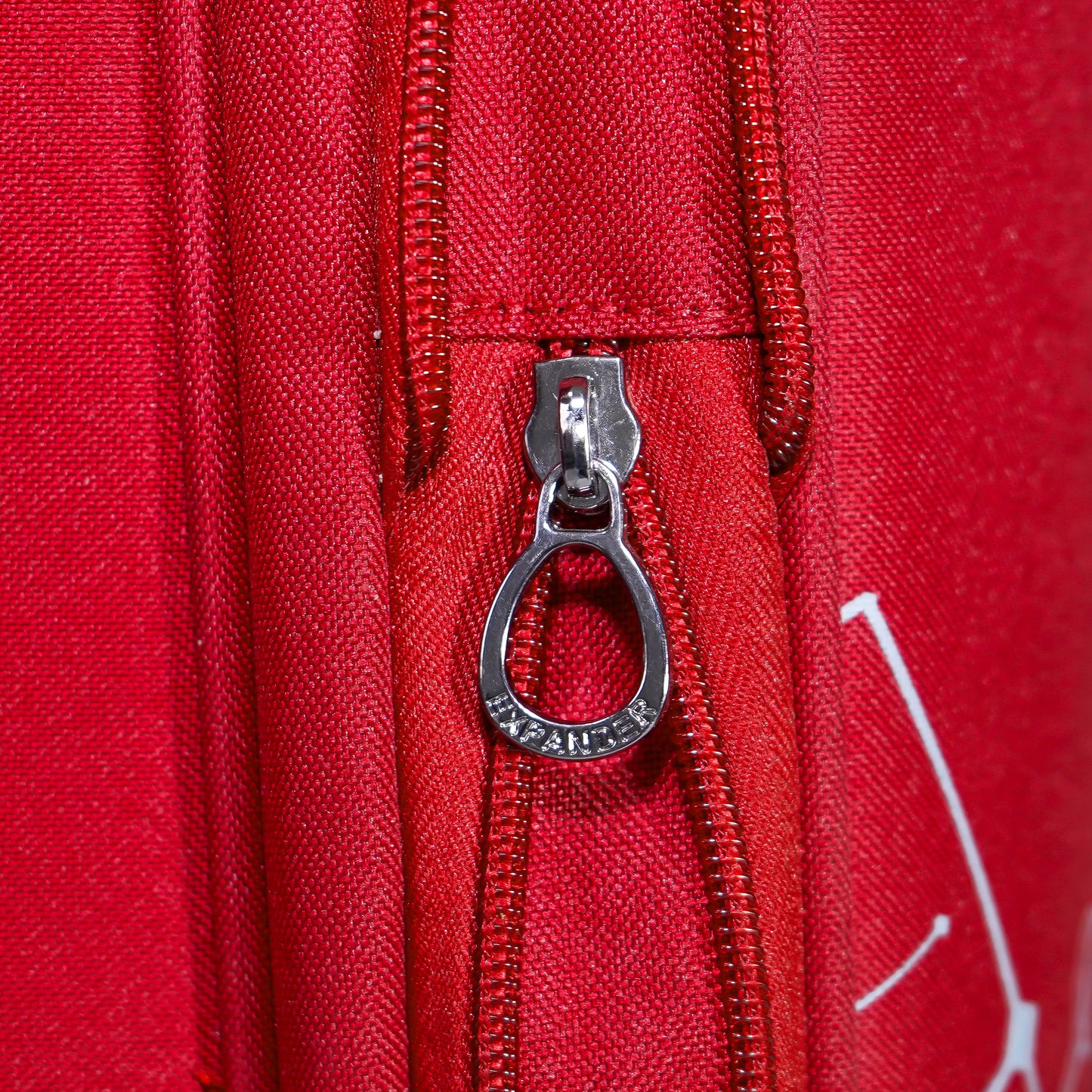 Expandable zipper on red Flash Plus soft luggage for extra packing space