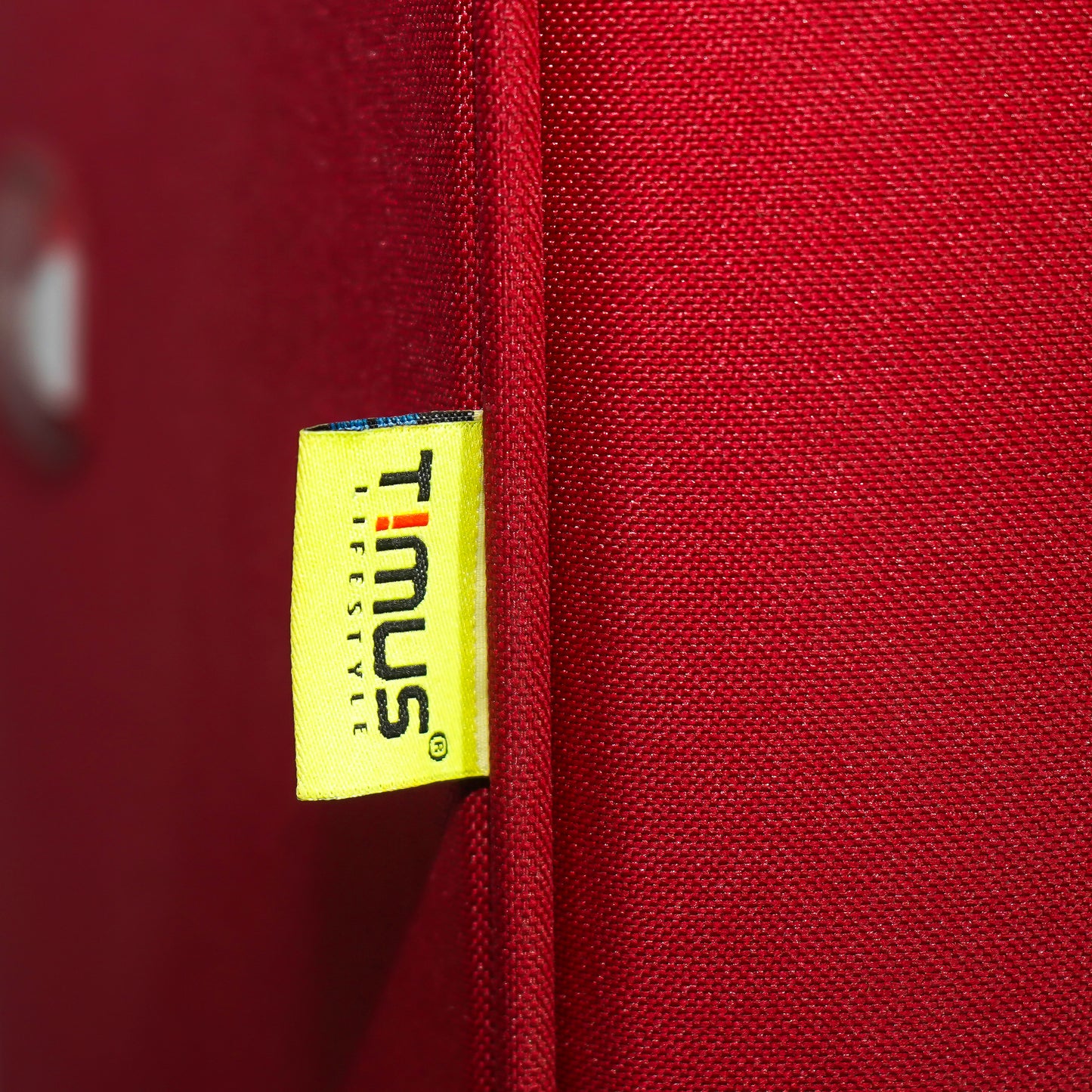 Timus brand tag on red Flash Plus soft luggage