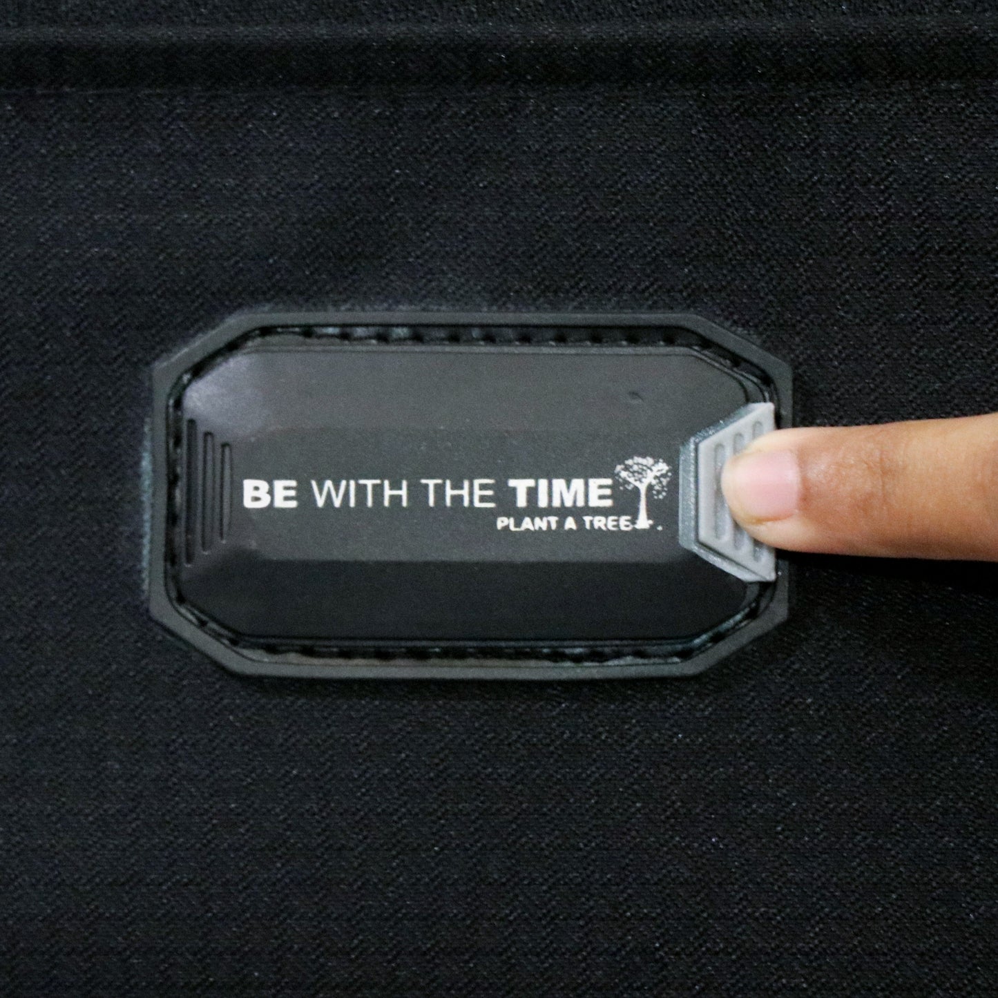 Close-up view of the name tag slot on Salsa Plus black luggage, designed for easy identification during travel