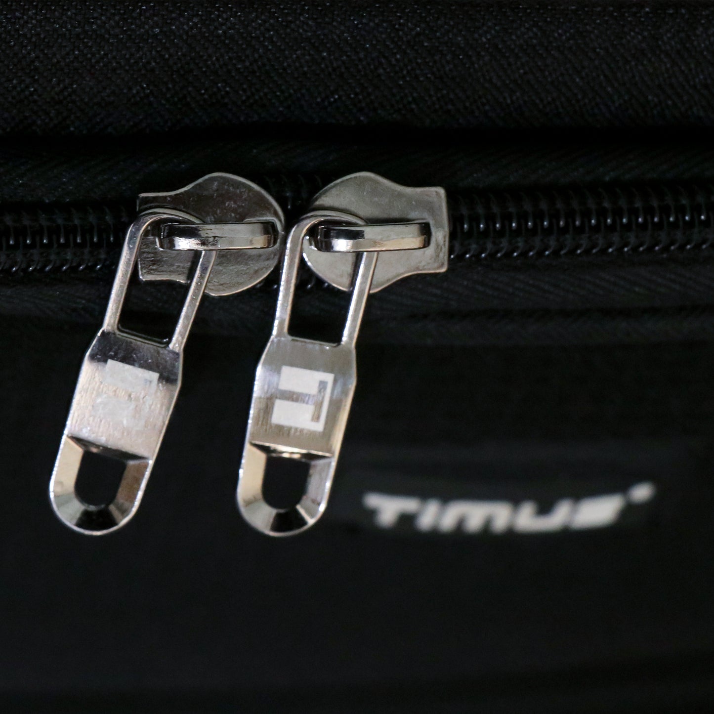 Close-up of premium zippers on the Salsa Plus black soft luggage highlighting smooth glide, high-quality finish, and durable stitching