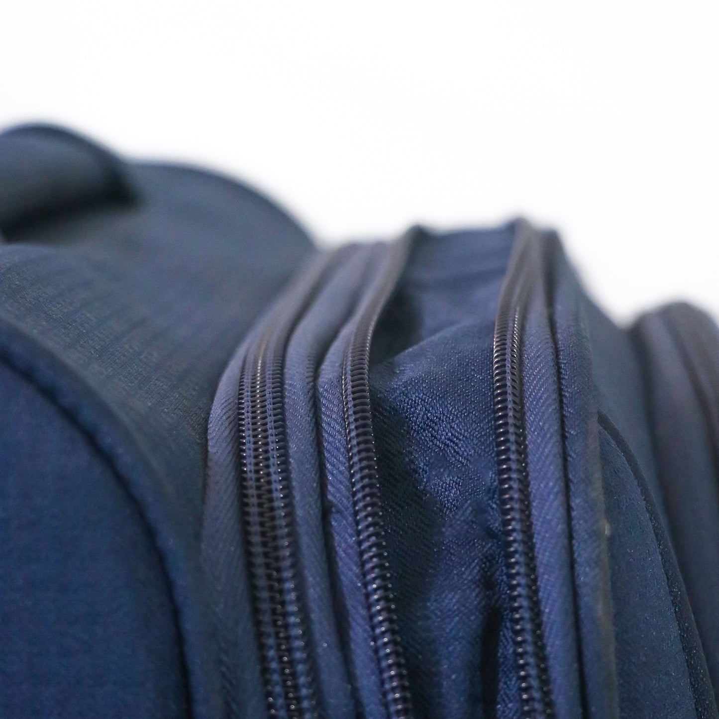 Open view of navy blue Salsa Plus luggage with expandable zippers unzipped, clearly showing the increased storage space for flexible packing.