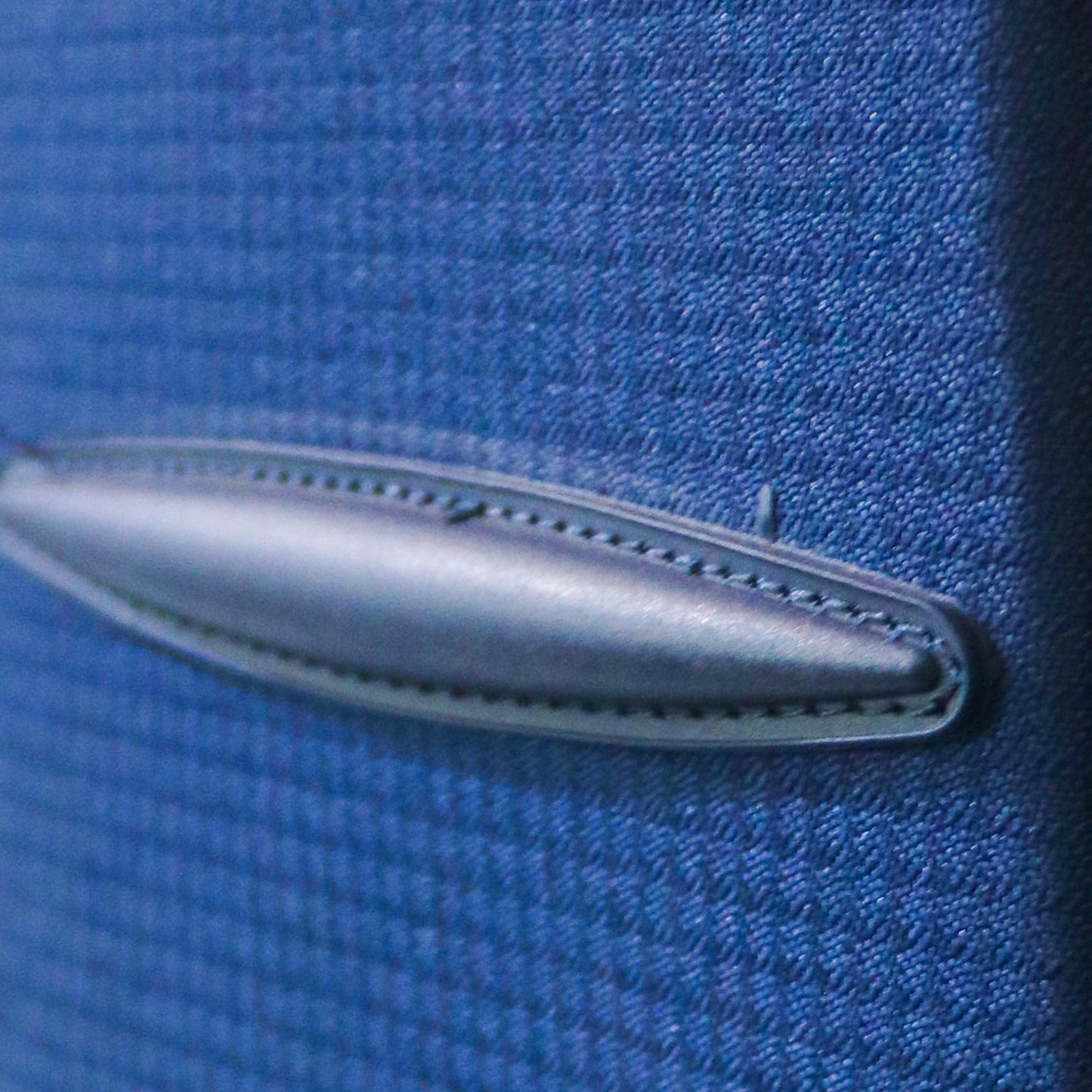 Side view showing the protective lug on navy blue Salsa Plus luggage, designed to prevent surface damage when laid flat or in transit.