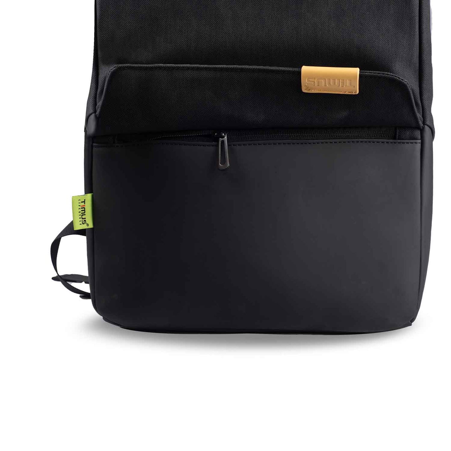 Close-up front view of the Timus Magnet Overnighter backpack in black, focusing on the bottom front pocket with a zipper and a small green Timus tag on the side.