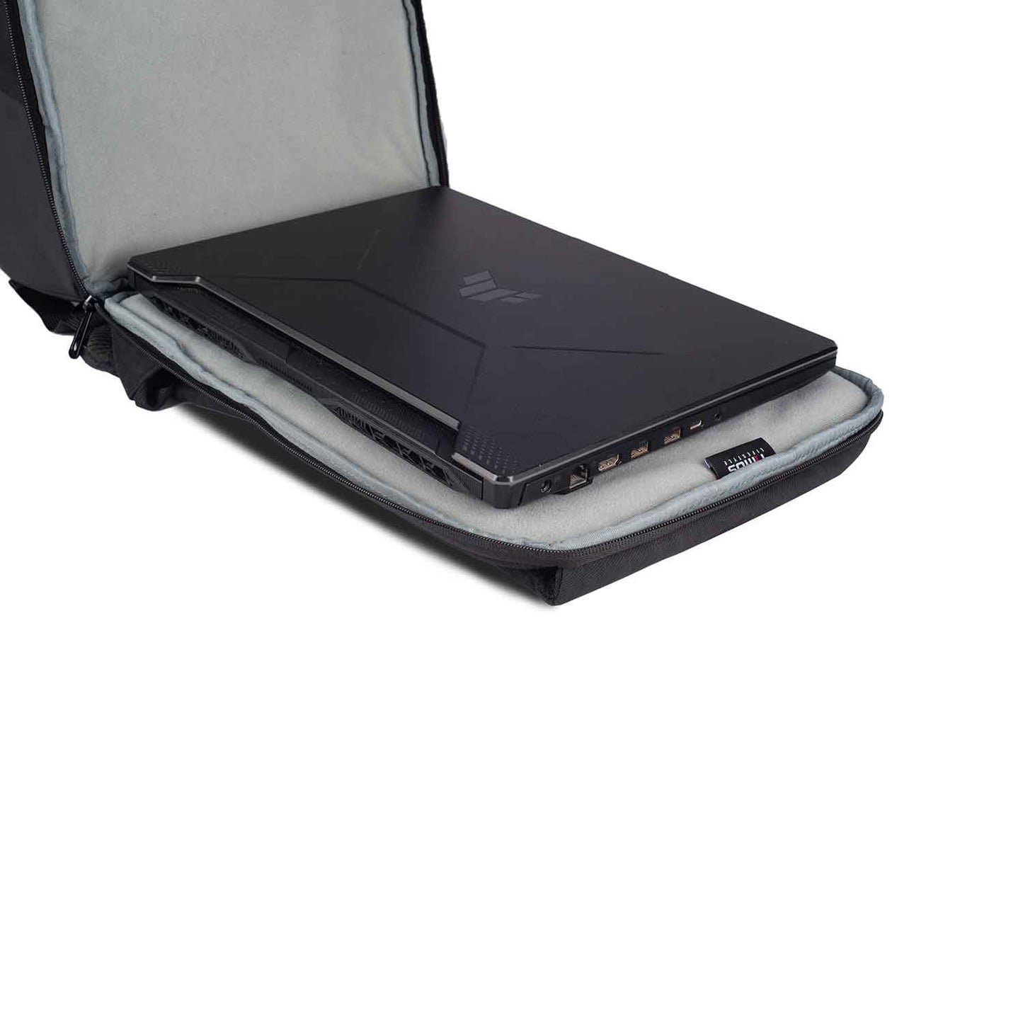 Close-up view of the Timus Magnet Overnighter backpack open flat with a black laptop inside its padded, grey fabric-lined laptop compartment.