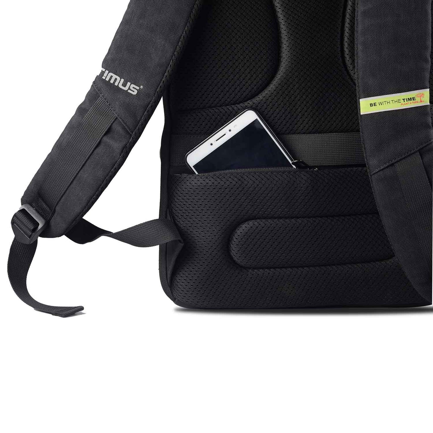 Close-up of black Timus Magnet Overnighter backpack rear side showing padded straps and breathable back panel with a mobile phone partially inserted into a hidden side pocket on the back panel.