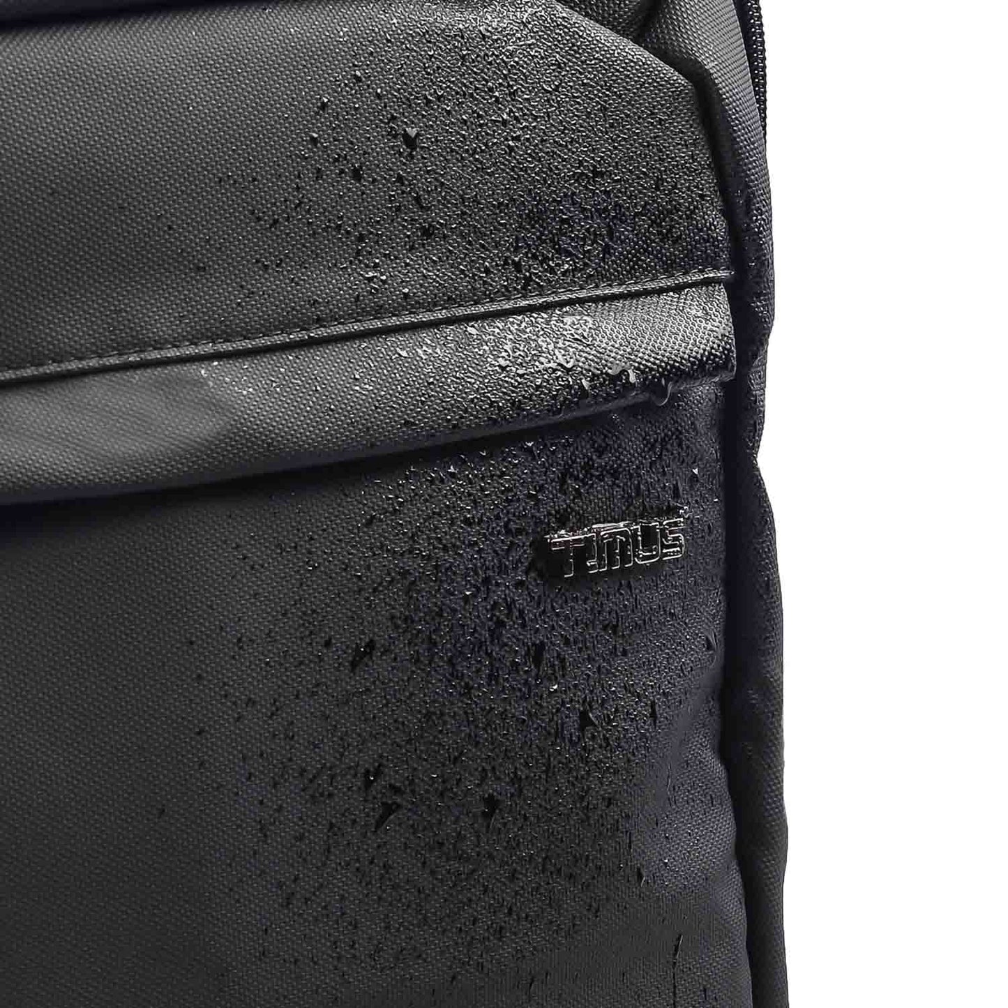 Close-up of water droplets on the front surface of a black Tokyo laptop backpack showing the TIMUS logo.