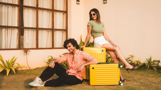 How to Plan Budget-Friendly Trips: Smart Travel Hacks – a young couple with Timus Neolite Hard Luggage in bright yellow, perfect for stylish and affordable travel.
