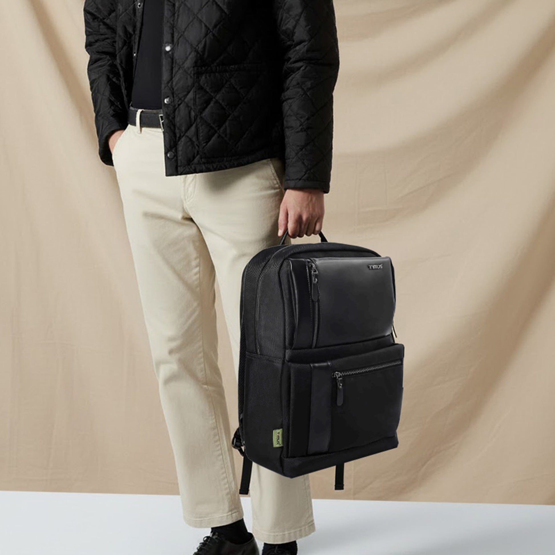 Man carrying the Timus Oslo black laptop backpack, reflecting a modern, professional, and travel-ready look.