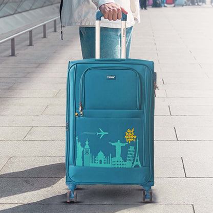 Lifestyle shot of Timus Salsa Plus blue luggage beside a traveler, highlighting premium tone and effortless mobility.