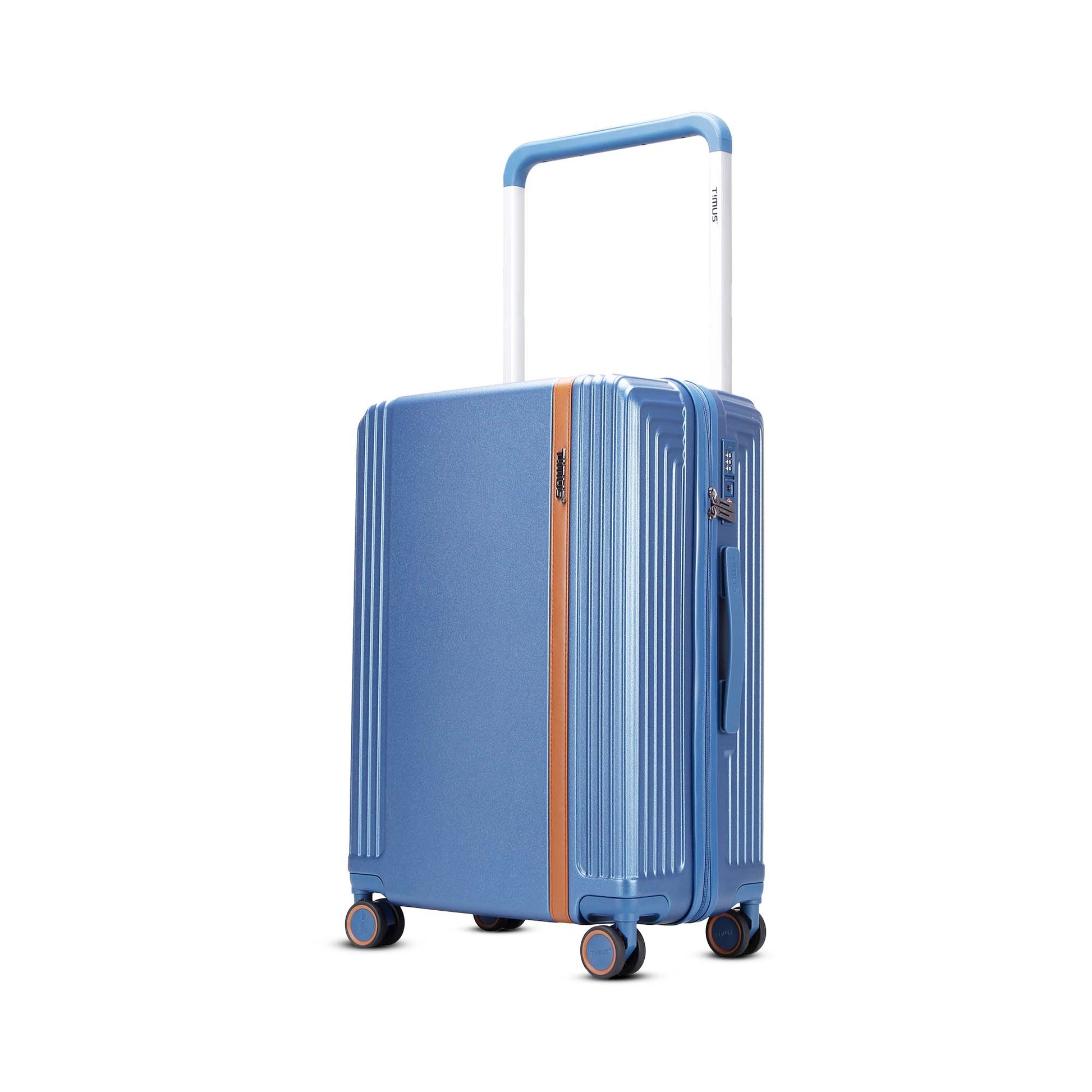 Left angled view of Timus Starlite blue 68 cm hard luggage featuring brown telescopic handle, TSA lock, and smooth spinner wheels.
