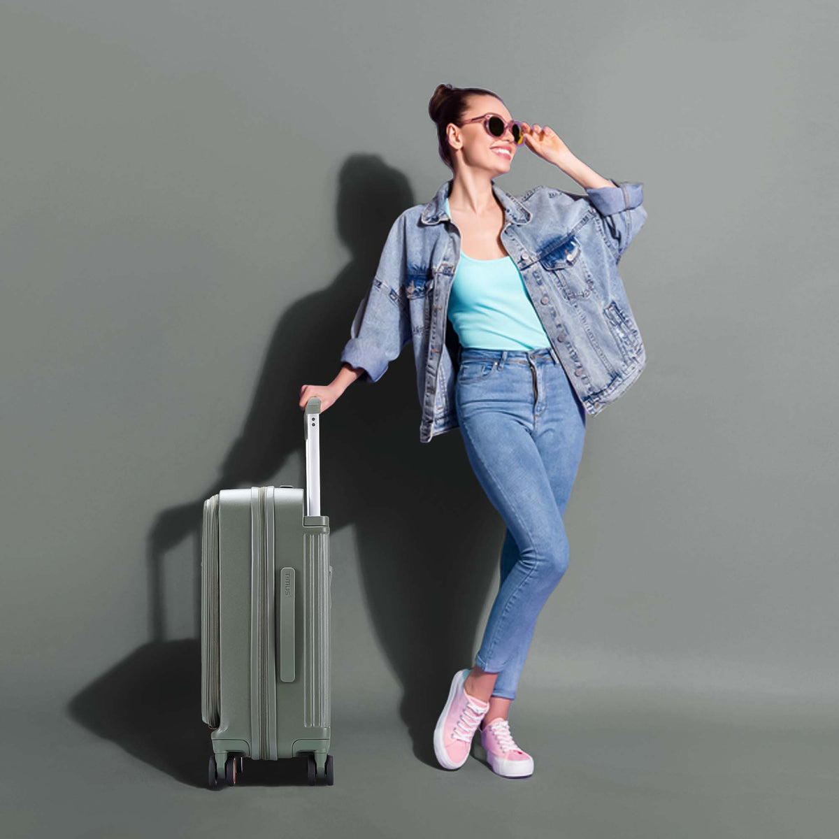 Model posing with Timus Starlite olive green luggage showcasing travel-ready and sophisticated design.