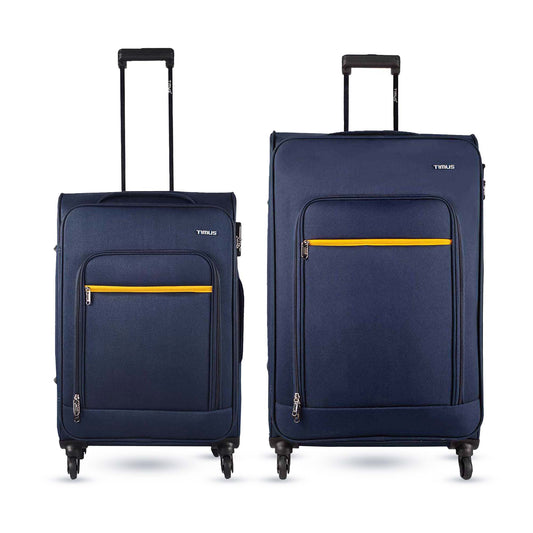Two pieces of Nexon soft luggage, one larger and one smaller, in blue color with yellow accents, featuring wheels and a trolley handle.