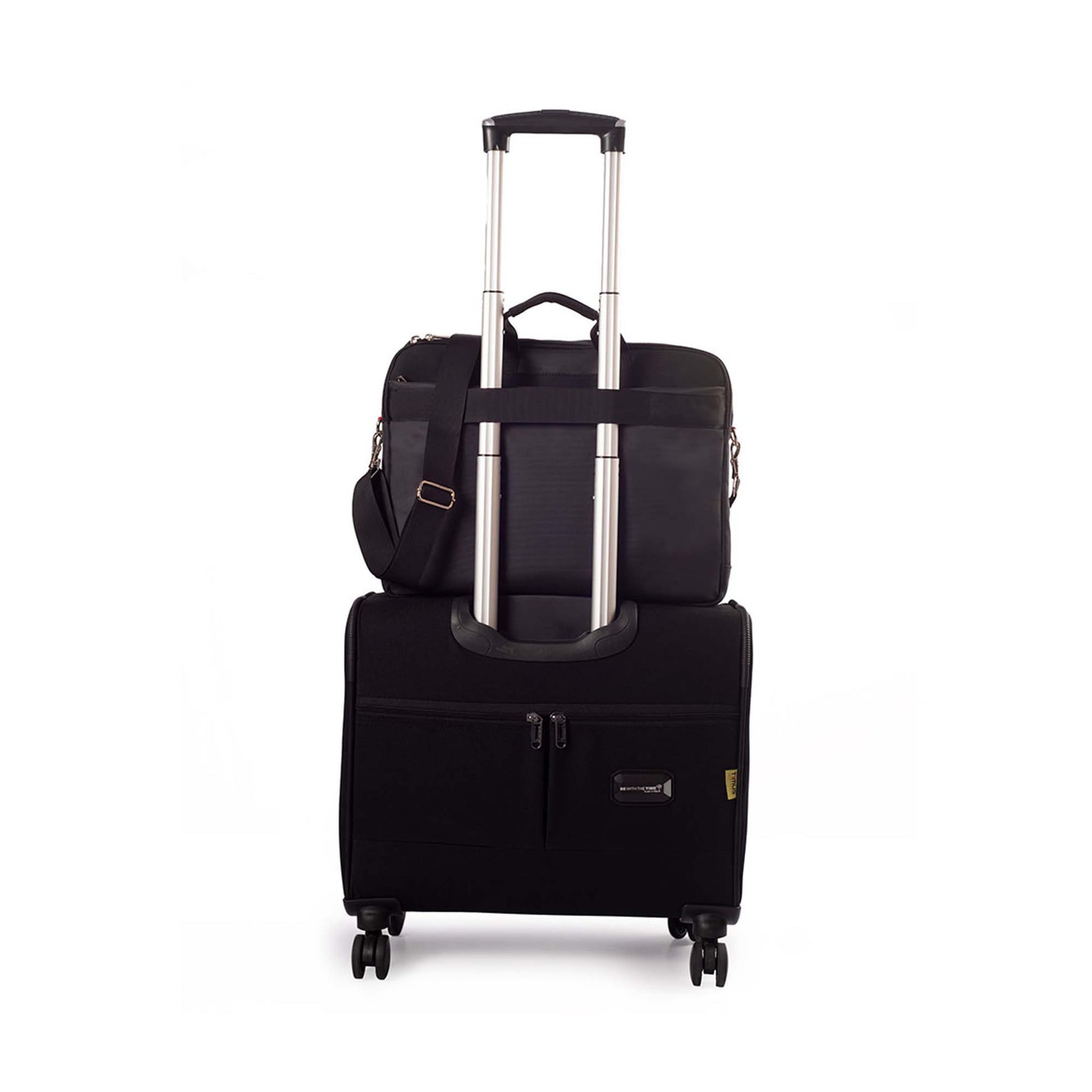 Black Timus New York laptop carry-on bag shown from the back, securely attached to the handle of a black rolling suitcase with dual spinner wheels on a white background.