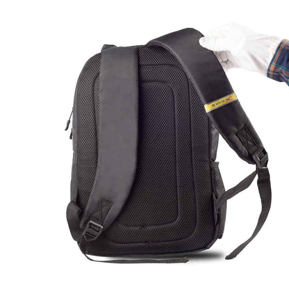Back view of Timus Spain casual backpack showing padded back panel and adjustable shoulder straps, with a gloved hand holding one strap.